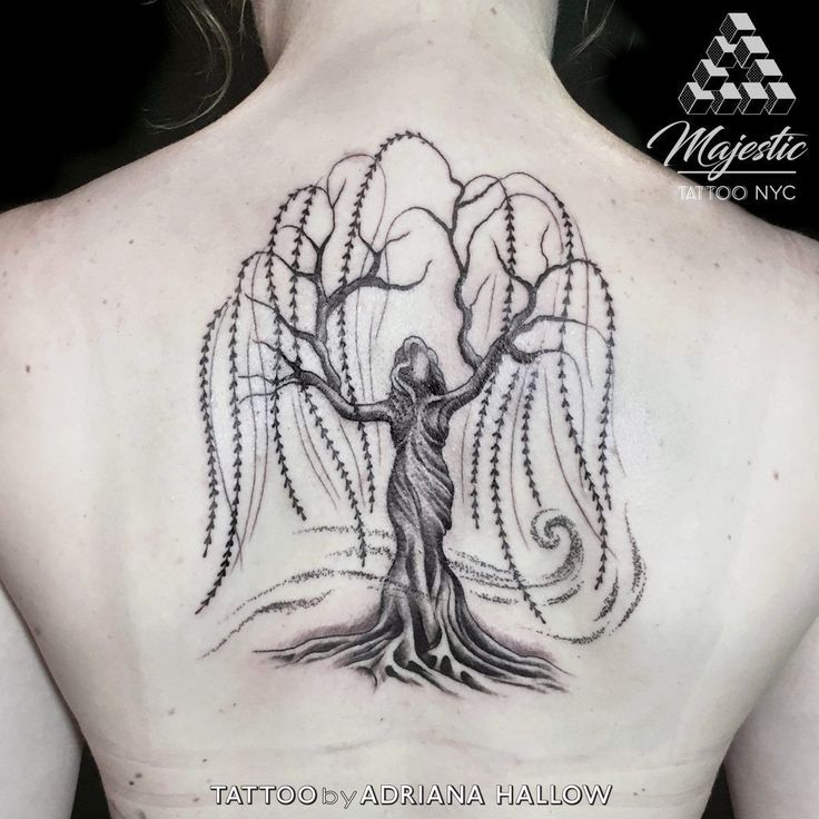 A Woman With A Tree Tattoo On Her Back