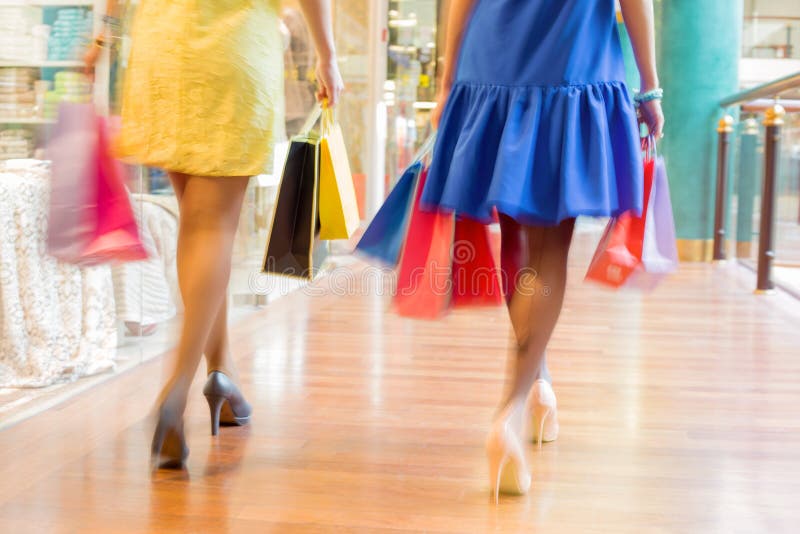 Two Beautiful Women Walking In Mall With Shopping Bags Stock Image