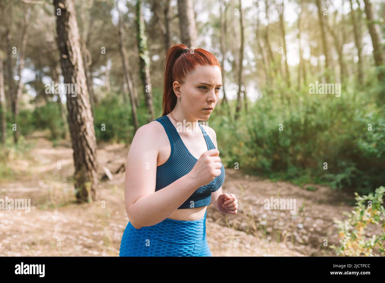 Young Woman Athlete Training Running In Nature To Tone The Body